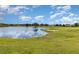 Picturesque golf course view showcasing lush greenery and sand traps near a pond at 3887 Atrium Dr # 3, Orlando, FL 32822