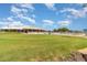 Expansive green golf course with a community building and pool in the background at 3887 Atrium Dr # 3, Orlando, FL 32822
