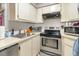 Kitchen featuring stainless steel appliances, white cabinetry, and ample counter space for meal preparation at 3887 Atrium Dr # 3, Orlando, FL 32822