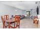 Living room and dining area with neutral paint, and tile flooring perfect for comfortable living and entertaining at 3887 Atrium Dr # 3, Orlando, FL 32822