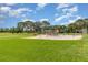 Community playground with swings and play equipment surrounded by lush green space at 3887 Atrium Dr # 3, Orlando, FL 32822
