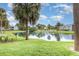 Scenic pond view in the community with picnic table and apartment buildings at 3887 Atrium Dr # 3, Orlando, FL 32822
