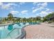 Inviting community pool with clear blue water, surrounded by palm trees and lounge chairs at 3887 Atrium Dr # 3, Orlando, FL 32822