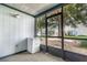 Cozy screened porch with outdoor space for storage and relaxation, overlooking a landscaped yard at 3887 Atrium Dr # 3, Orlando, FL 32822