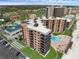 Condo community featuring pool, tennis courts, shuffleboard, manicured lawns, and a sandy beach at 4141 S Atlantic Ave # 707, New Smyrna Beach, FL 32169