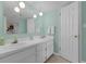 Well-lit bathroom featuring double sinks, modern fixtures, and neutral tones for a soothing ambiance at 4141 S Atlantic Ave # 707, New Smyrna Beach, FL 32169