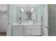 Well-lit bathroom featuring double sinks, modern fixtures, and a glass-enclosed shower for a spa-like experience at 4141 S Atlantic Ave # 707, New Smyrna Beach, FL 32169