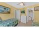 Bedroom featuring twin beds, artwork, closet, and dresser with a TV at 4141 S Atlantic Ave # 707, New Smyrna Beach, FL 32169
