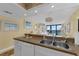 Kitchen with breakfast bar open to living area, double sink and open floor plan at 4141 S Atlantic Ave # 707, New Smyrna Beach, FL 32169