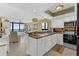 Kitchen open to living room with bar seating, ocean view, and modern appliances at 4141 S Atlantic Ave # 707, New Smyrna Beach, FL 32169