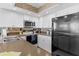 Updated kitchen featuring white cabinets, black appliances, and stylish backsplash at 4141 S Atlantic Ave # 707, New Smyrna Beach, FL 32169