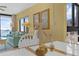 Cozy living space featuring a dining table with ocean views, comfortable seating and sunny, coastal décor at 4141 S Atlantic Ave # 707, New Smyrna Beach, FL 32169