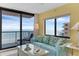Living room with large windows offering ocean views and comfortable, stylish furnishings at 4141 S Atlantic Ave # 707, New Smyrna Beach, FL 32169
