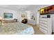 Spacious main bedroom with comfortable furnishings, including a sofa and dresser for ample storage at 4141 S Atlantic Ave # 707, New Smyrna Beach, FL 32169