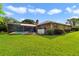 Expansive backyard featuring a pool, patio, and lush lawn, perfect for outdoor entertaining and relaxation at 428 N Pine Meadow Dr, Debary, FL 32713