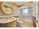 Elegant bathroom features marble vanity, decorative mirror, and tiled shower at 428 N Pine Meadow Dr, Debary, FL 32713