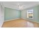 Neutral bedroom with hardwood floors, ceiling fan, and ample closet space at 428 N Pine Meadow Dr, Debary, FL 32713