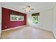Bright bedroom with hardwood floors, fan, and large windows overlooking backyard at 428 N Pine Meadow Dr, Debary, FL 32713
