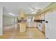 Bright kitchen with wooden cabinets, granite countertops, and stainless steel appliances overlooking an open living area at 428 N Pine Meadow Dr, Debary, FL 32713