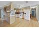 Bright kitchen with wooden cabinets, granite countertops, and stainless steel appliances overlooking an open living area at 428 N Pine Meadow Dr, Debary, FL 32713