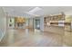 Spacious living room boasts stone fireplace, skylight, and open layout to kitchen at 428 N Pine Meadow Dr, Debary, FL 32713