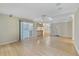 Open living room features hardwood floors, great natural light, and access to kitchen at 428 N Pine Meadow Dr, Debary, FL 32713