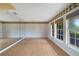 Living room featuring wood floors, large windows, natural light, and a wall mirror at 428 N Pine Meadow Dr, Debary, FL 32713