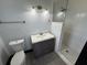 This bathroom is equipped with a shower, vanity, lighting and toilet at 4534 Lemans Dr, Orlando, FL 32808