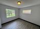 This bedroom has gray wood-look floors and two windows at 4534 Lemans Dr, Orlando, FL 32808