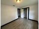 This bedroom includes gray wood-look floors, one window and a closet at 4534 Lemans Dr, Orlando, FL 32808