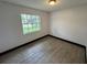 This bedroom has gray wood-look floors, one window and electrical outlets at 4534 Lemans Dr, Orlando, FL 32808