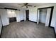 This bedroom includes gray wood-look floors, closet space and a bathroom with vanity at 4534 Lemans Dr, Orlando, FL 32808