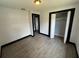 This bedroom includes gray wood-look floors, closet and an electrical outlet at 4534 Lemans Dr, Orlando, FL 32808