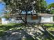Charming single-story home with white painted brick and blue shutters at 4534 Lemans Dr, Orlando, FL 32808