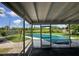This patio has a screened view of the backyard and pool covered with a tarp at 4534 Lemans Dr, Orlando, FL 32808