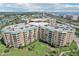 Aerial view features a condo complex with balconies and lush landscaping, plus ocean and waterway views at 4650 Links Village Dr # B103, Ponce Inlet, FL 32127