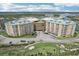Expansive aerial view of condo building and community including the golf course and Intracoastal Waterway in the background at 4650 Links Village Dr # B103, Ponce Inlet, FL 32127