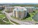Aerial view of a waterfront condo community with tennis courts at 4650 Links Village Dr # B103, Ponce Inlet, FL 32127