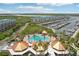 Aerial view of a community pool, marina, and condo complex with lush landscaping at 4650 Links Village Dr # B103, Ponce Inlet, FL 32127