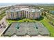 Aerial view of tennis courts and luxurious condos at a beach resort at 4650 Links Village Dr # B103, Ponce Inlet, FL 32127