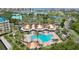 Overhead view of community pool, clubhouse and lush green landscapes at 4650 Links Village Dr # B103, Ponce Inlet, FL 32127