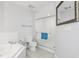 Bright white bathroom featuring a tub, glass enclosed shower, and tiled floor at 4650 Links Village Dr # B103, Ponce Inlet, FL 32127