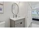 Elegant bathroom featuring a quartz countertop, a gray vanity, and neutral finishes, creating a soothing ambiance at 4650 Links Village Dr # B103, Ponce Inlet, FL 32127