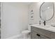 Stylish bathroom featuring a gray vanity with a modern sink, marble countertop, and elegant fixtures at 4650 Links Village Dr # B103, Ponce Inlet, FL 32127