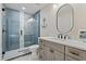 Beautiful bathroom featuring a glass enclosed shower, neutral cabinets, and decorative anchor art at 4650 Links Village Dr # B103, Ponce Inlet, FL 32127