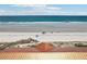 An ocean view shows the beach with beach access and the ocean stretching to the horizon at 4650 Links Village Dr # B103, Ponce Inlet, FL 32127