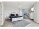 Serene bedroom with a blue quilt, a white bed frame, a workspace, and a window, creating a peaceful retreat at 4650 Links Village Dr # B103, Ponce Inlet, FL 32127