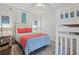 Charming bedroom featuring a queen bed, bunk beds, and colorful decor at 4650 Links Village Dr # B103, Ponce Inlet, FL 32127