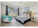 Bright bedroom featuring a ceiling fan and a sliding glass door at 4650 Links Village Dr # B103, Ponce Inlet, FL 32127
