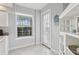 Bright breakfast nook with a door to the outside, complemented by white cabinets and stylish decor at 4650 Links Village Dr # B103, Ponce Inlet, FL 32127